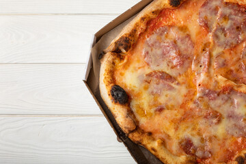 Delicious hot and fragrant pizza diabla with piperoni. Pizza in a box. Pizza delivery. Composition...