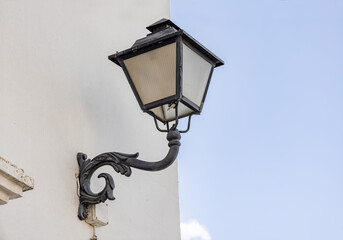 Iron wall lamp in a whitewashed wall