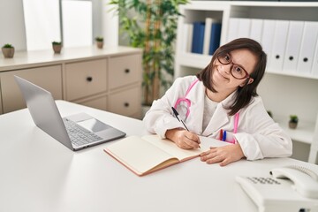 Down syndrome woman wearing doctor uniform working at clinic