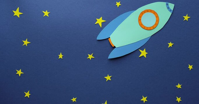 A rocket cut out of paper flies against the background of the night starry sky. 4K stop motion animation