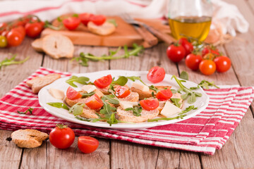 Friselle with cherry tomatoes and arugula.