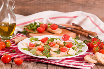 Friselle with cherry tomatoes and arugula.