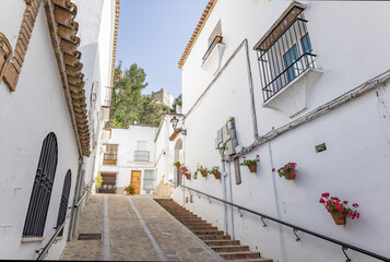 Fototapeta na wymiar Typical narrow street in Zahara de la Sierra, in Sierra de Grazalema, Cadiz, Andalusia, Spain
