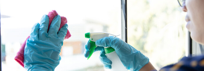 Cleaning staff operator injects alcohol and Use a cloth to wipe the window or glass, Cleaning windows with antiseptic or virus remover, Prevention of accumulated pathogens, Spread of virus