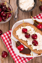 Rye bread with cottage cheese and cherries.