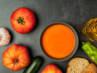 Cold Spanish soup Homemade Gazpacho served in a bowl with vegetables around it