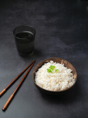 White rice in the bowl with dark background