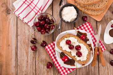 Rye bread with cottage cheese and cherries.