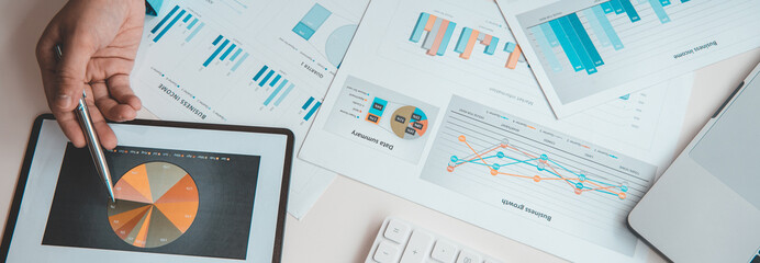 Financial businessman analyze the graph of the company's performance to create profits and growth,...