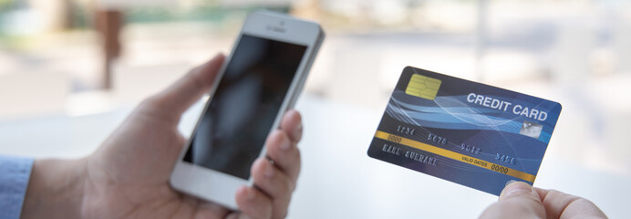 Businessman use mobile phones to register for security Online with a credit card to buy products online through application, Online shopping or Internet technology concept.