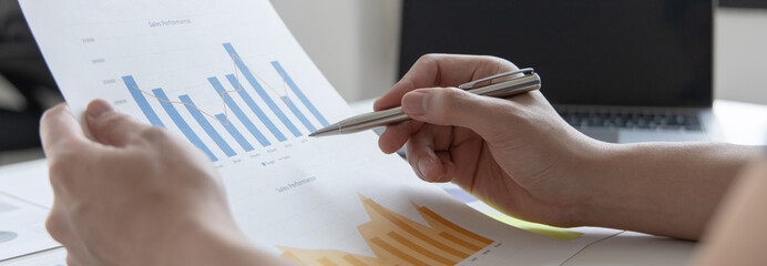 Financial businessman analyze the graph of the company's performance to create profits and growth,...