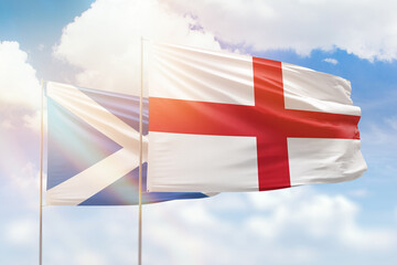 Sunny blue sky and flags of england and scotland