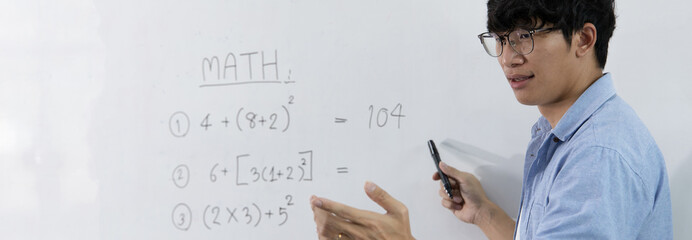 Asian teachers are teaching mathematics classes in addition, subtraction, multiplication, and division in high school or university classrooms, math quiz on a white board.