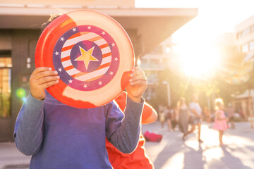 Latin boy with american flag frisbee playing on the street