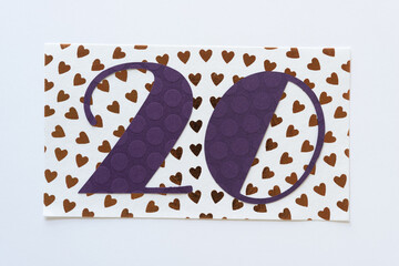 the number 20 on paper with hearts