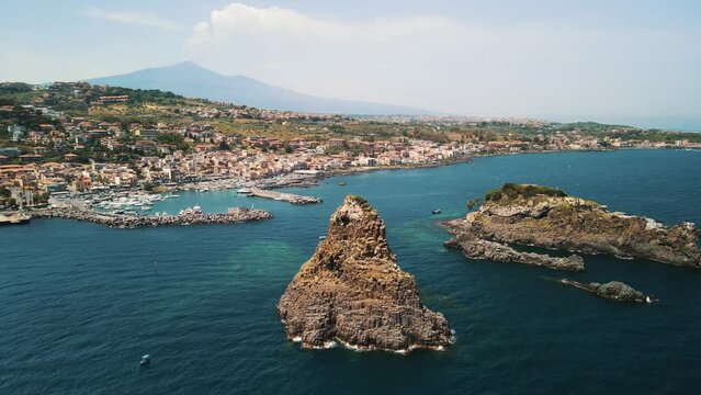 Aerial View of the Faraglioni of Acitrezza. Rocks of the Cyclops, typical lava stacks. Sicily, Italy. 