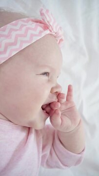close up of cute infant sucking fingers