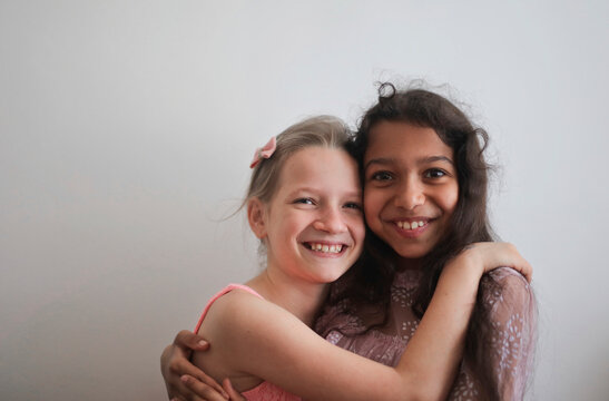 two smiling embraced little girls