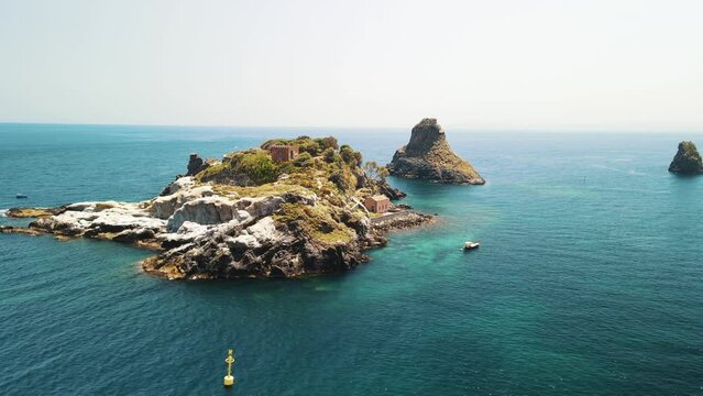 Aerial View of the Faraglioni of Acitrezza. Rocks of the Cyclops, typical lava stacks. Sicily, Italy. 