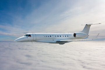 White modern luxury private jet flies in the air above the clouds