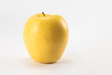 Yellow apple isolated on bright background. Close up view.
