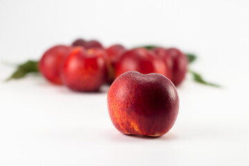 Nectarine fruits isolated on bright background. Close up view. Selective focus.