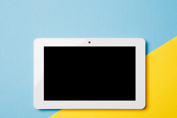 white tablet on the background of the flag of Ukraine