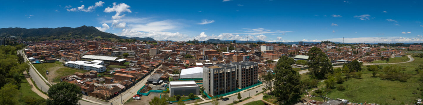 Carmen de Viboral Cityscape with Mountain Range in the Background and Half Built Residential Units in Antioquia / Colombia
