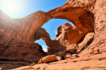 Double arch, The Windows, Arches National Park, Utah, USA. Desert rock formation under sunny blue...