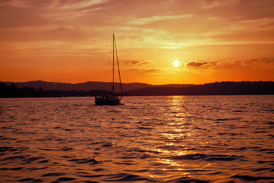 Motoring Sailboat at Sunset