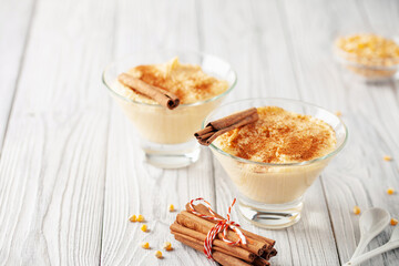 Curau de Milho (Brazilian Corn Pudding). Traditional Brazilian dessert. Corn porridge with cinnamon in a bowl.