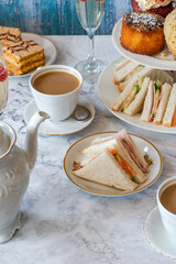 Selection of gourmet cakes and mini canapes with coffee and sparkling wine on a table