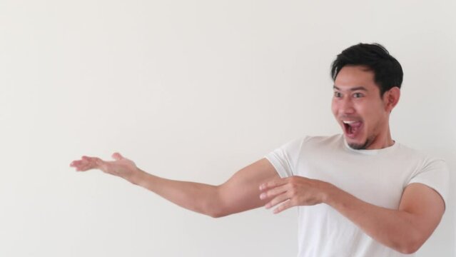 Happy asian man with his weird funny dance on white background.
