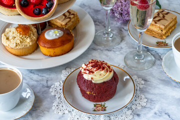 Selection of gourmet cakes with coffee and sparkling wine on a table