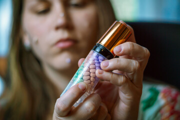 beautiful and sensual woman putting on makeup in a mirror