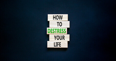 Destress your life symbol. Concept words How to destress your life on wooden blocks. Beautiful black table black background. Copy space. Psychological business destress your life concept. Copy space.