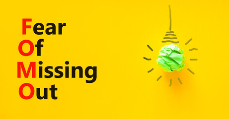 FOMO fear of missing out symbol. Concept words FOMO fear of missing out on beautiful yellow...