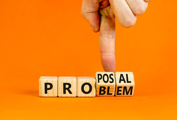 Solving a problem and making proposal symbol. Businessman turns wooden cubes and changes the word Problem to Proposal. Beautiful orange background. Business problem to proposal concept. Copy space.