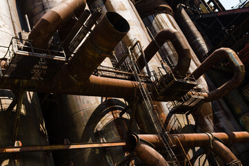 Massive rusty system of tubes and pipes in adandoned industrial area