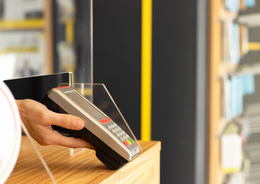 Dependent with dataphone in hand waiting for payment