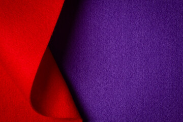 Abstract geometric felt texture background. Creative geometric curved felt textile background in purple and red colors. Top view, copy space