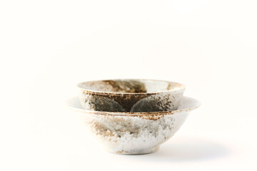 Traditional ceramic bowls on bright paper background. Soft focus. Close up. Copy space.