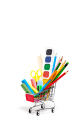 School supplies and stationery in a shopping basket white background.Preparing child for school year.