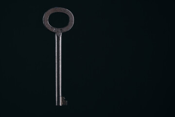 Old, retro vintage key black background.