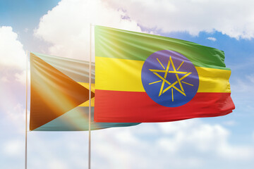 Sunny blue sky and flags of ethiopia and bahamas