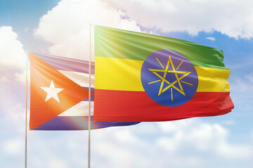 Sunny blue sky and flags of ethiopia and cuba