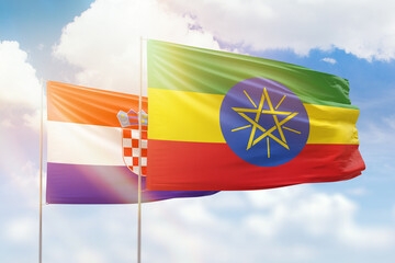 Sunny blue sky and flags of ethiopia and croatia