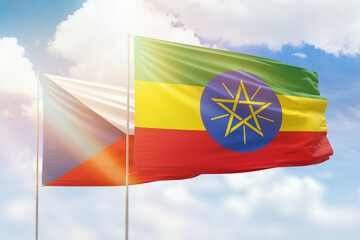 Sunny blue sky and flags of ethiopia and czechia