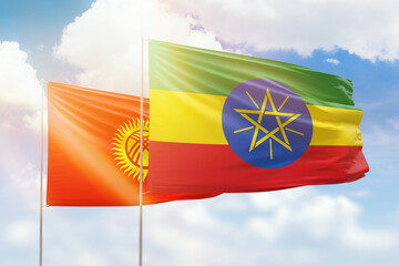 Sunny blue sky and flags of ethiopia and kyrgyzstan