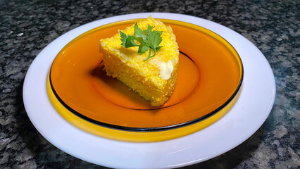 Delicious couscous with butter and a parsley leaf to garnish the dish.